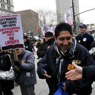 Nearly 1,000 public workers and their unions massed at lunch time in front of City Hall.